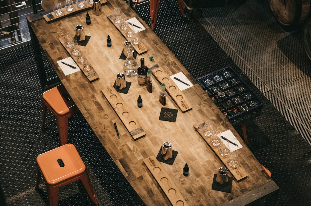 Editorial team meeting around a table with laptops